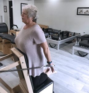 happy older woman doing Pilates in a classical studio in Peewee Valley KY