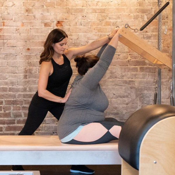 Erica Walters, the owner of Pilates Fit Studio in Louisville KY, is teaching a private beginner Pilates session
