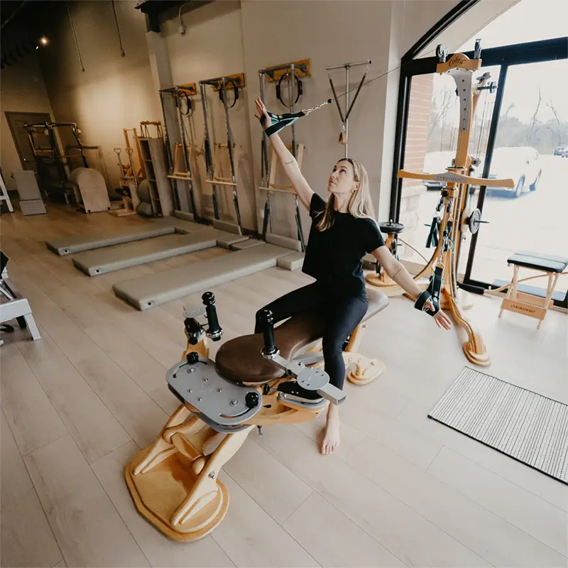 gyrotonic-louisville Woman practicing Gyrotonic training on the Pulley Tower Combination Unit at Pilates Fit Studio in Louisville, KY